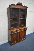 A VICTORIAN FLAME MAHOGANY BOOKCASE, the top with two glazed doors, enclosing three fixed shelves,