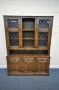 A 20TH CENTURY OAK DRESSER, the top fitted with an arrangement of lead glazed doors and shelving,
