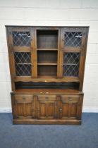 A 20TH CENTURY OAK DRESSER, the top fitted with an arrangement of lead glazed doors and shelving,