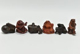 SIX 20TH CENTURY CARVED TREEN NETSUKE, all in the form of frogs / toads, three with inset eyes, four