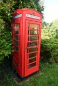 A K6 RED TELEPHONE BOX, the distinctive shape with a domed top, crown and telephone sign to all