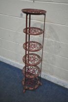 A BURGUNDY PAINTED CAST ALUMINIUM SIX TIER PAN STAND, of a tapered form, on paw feet, height