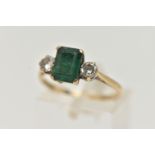 A 9CT GOLD EMERALD AND DIAMOND RING, designed as a central emerald cut emerald in a four claw