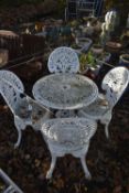 A WHITE PAINTED CAST ALUMINIUM CIRCULAR GARDEN TABLE, three matching chairs, and a similar chair (