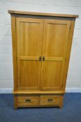 A SOLID OAK DOUBLE DOOR WARDROBE, with two drawers, width 110cm x depth 60cm x height 191cm (