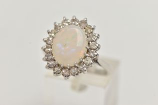 AN OPAL AND DIAMOND CLUSTER RING, designed as a central oval opal cabochon within a single cut