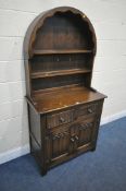 A 20TH CENTURY OAK DRESSER, the arched top with a two tier plate rack, on a base with two drawers