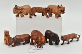 EIGHT 20TH CENTURY CARVED TREEN NETSUKE, carved as rhinos, an elephant, tiger and other large