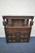 A 20TH CENTURY OAK COURT CUPBOARD, the top with a single cupboard door, scrolled and foliate
