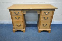 A MODERN PINE KNEE HOLE DESK, fitted with two banks of three drawers, on bracket feet, width 123cm x