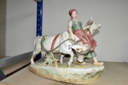 A ROYAL DUX FIGURE OF A WOMAN LEADING OXEN, signed in mould 'Dobrich', bearing pink triangle