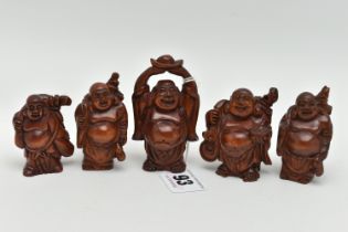 FOUR 20TH CENTURY CARVED TREEN OKIMONO AND A NETSUKE, all in the form of standing buddha, all with