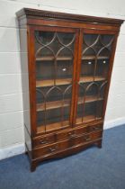 A 20TH CENTURY MAHOGANY BOOKCASE, the double astragal glazed doors enclosing three adjustable