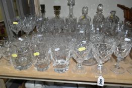 A QUANTITY OF CUT CRYSTAL AND GLASSWARE, comprising mid- century smoked glass decanters, three other