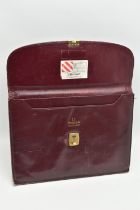 AN 'OMEGA' BURGUNDY LEATHER DOCUMENTATION FOLDER, large rectangular wallet with slide release clasp,