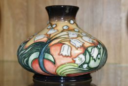 A MOORCROFT POTTERY LIMITED EDITION SQUAT BALUSTER VASE DECORATED WITH A LILY OF THE VALLEY