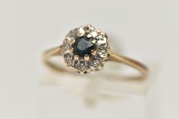 A 9CT GOLD DIAMOND AND SAPPHIRE RING, a circular cut blue sapphire, prong set with eight single