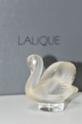 A BOXED LALIQUE SWAN PAPERWEIGHT, with frosted swan on a clear circular base, height 4.5cm, with