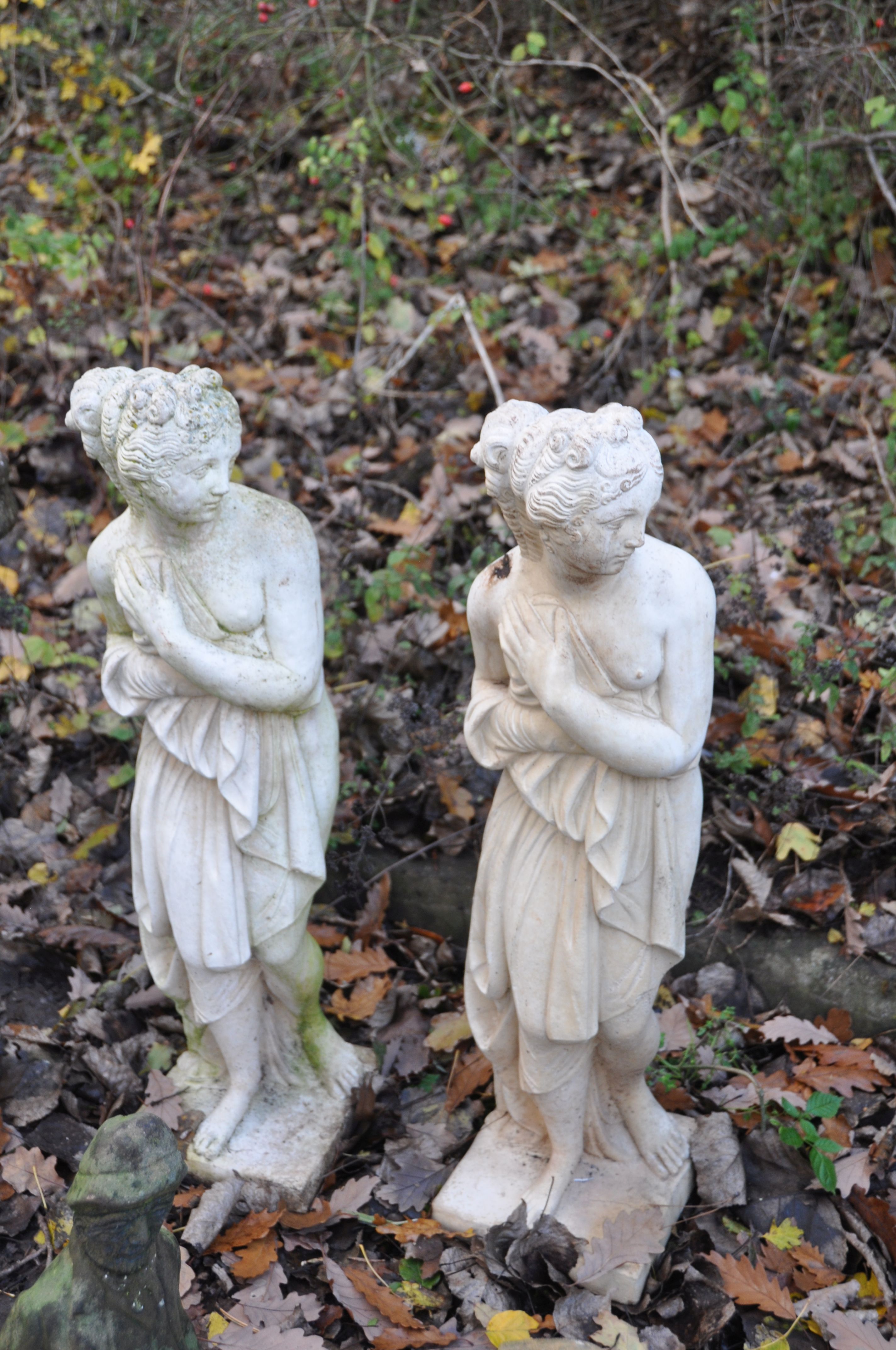 A MATCHING PAIR OF COMPOSITE GARDEN FIGURES, of two scantily clad ladies, height 79cm (condition
