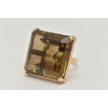 A 9CT GOLD SMOKY QUARTZ RING, designed as a large square smoky quartz within a four claw setting,