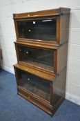 AN OAK GLOBE WERNICKE BOOKCASE, the three graduated sections with bevelled glass hide and fall