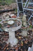 A WEATHERED COMPOSITE BIRD BATH, of a tree type form, diameter 47cm x height 62cm, and another