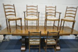 A SOLID OAK RECTANGULAR DINING TABLE, with two additional leaves, on trestle legs, united by a block