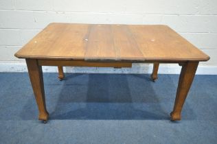 AN ARTS AND CRAFTS OAK WIND OUT DINING TABLE, with two additional leaves and one winding handle,