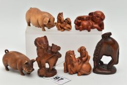 SIX 20TH CENTURY CARVED TREEN NETSUKE AND AN OKIMONO, carved as pigs, horses, goat, etc, all with