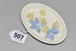 A MOORCROFT POTTERY OVAL PIN DISH DECORATED WITH A CAMPANULA PATTERN ON A CREAM GROUND, impressed