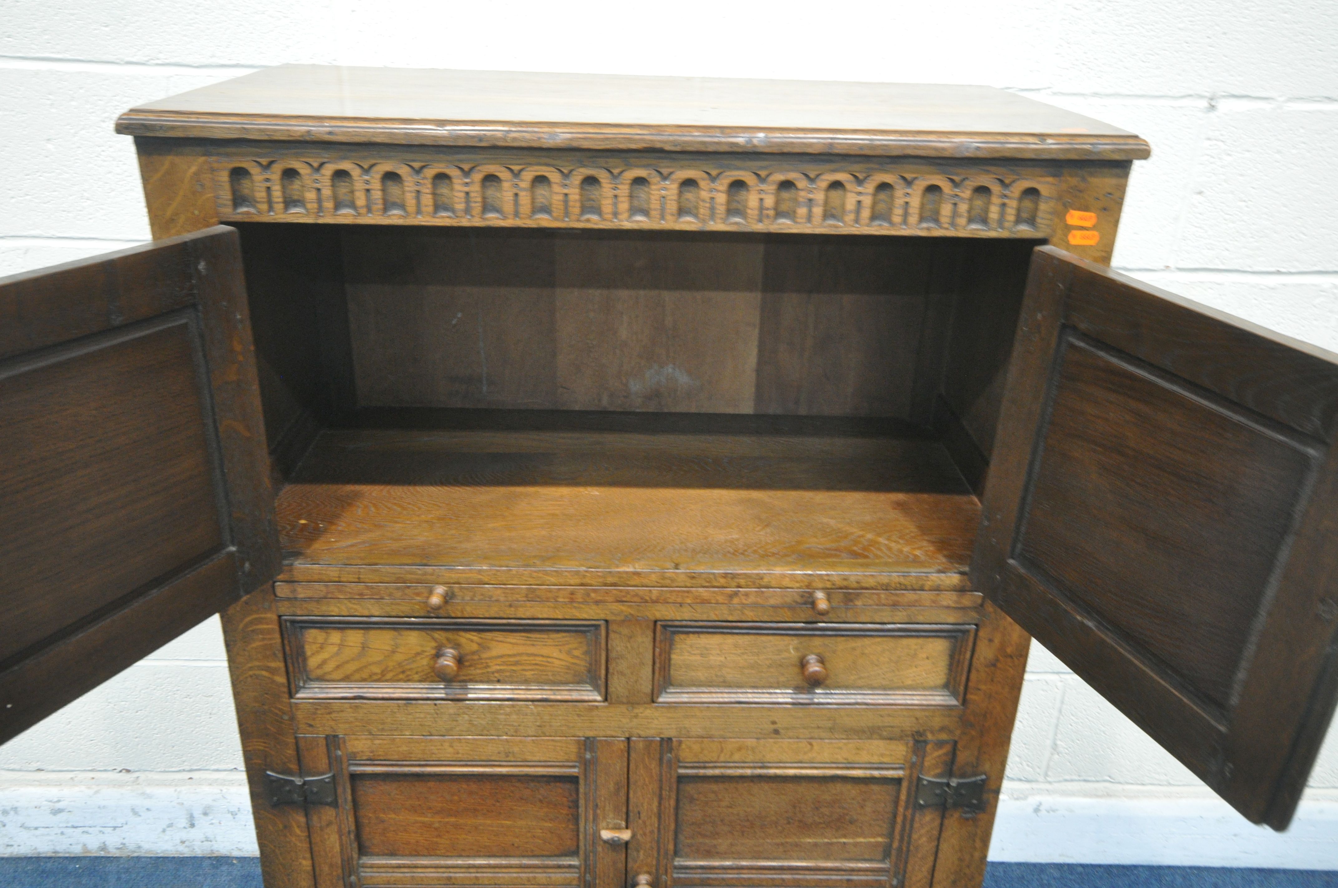 A 20TH CENTURY SOLID OAK CABINET, fitted with two cupboard doors, carved with an archway, a brushing - Image 2 of 6