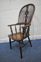 A 19TH CENTURY STAINED ELM WINDSOR ARMCHAIR, with spindled back rest, turned supports, legs and