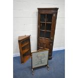 IN THE MANNER OF TITCHMARSH AND GOODWIN, A SOLID OAK CORNER CUPBOARD, with a glazed door, above a
