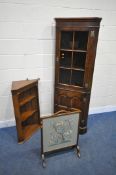 IN THE MANNER OF TITCHMARSH AND GOODWIN, A SOLID OAK CORNER CUPBOARD, with a glazed door, above a
