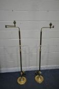A PAIR OF BRASS STANDARD LAMPS, with a swing arm mechanism, height 157cm (condition report: