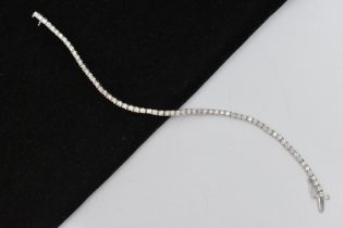 A 9CT WHITE GOLD DIAMOND LINE BRACELET, designed as sixty-four round brilliant cut diamonds each