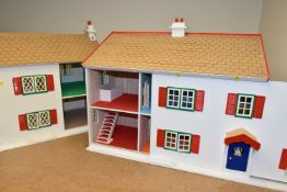 TWO WOODEN DOLL'S HOUSES, modelled as a detached house with side garage, front opening, no furniture