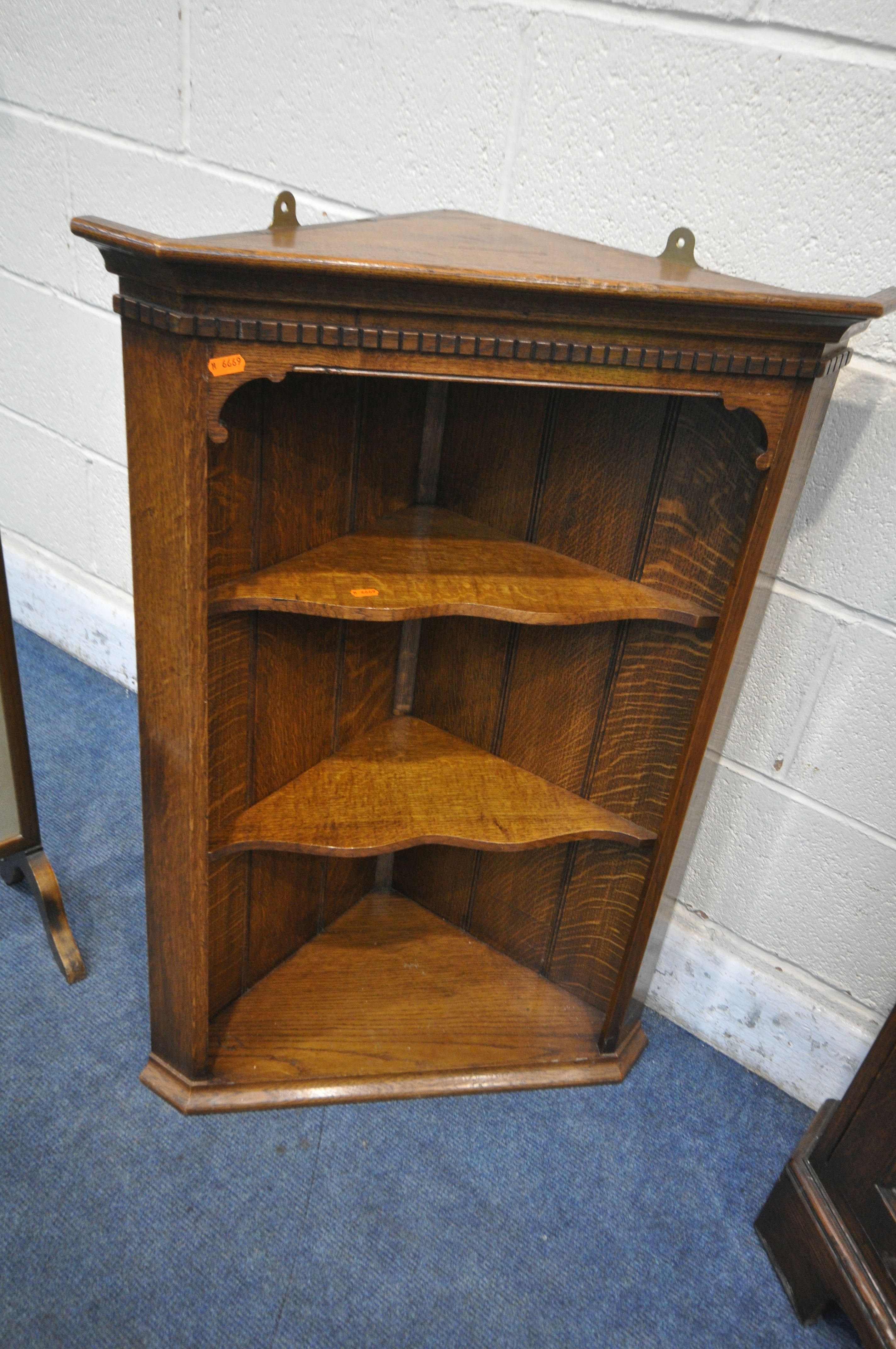 IN THE MANNER OF TITCHMARSH AND GOODWIN, A SOLID OAK CORNER CUPBOARD, with a glazed door, above a - Image 3 of 4
