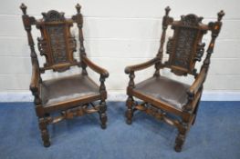 A PAIR OF EARLY 20TH CENTURY OAK THRONE CHAIRS, carved with floral crest, flanked by two finials,