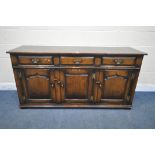 IN THE MANNER OF TITCHMARSH AND GOODWIN, A SOLID OAK SIDEBOARD, with three drawers above three