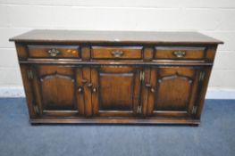 IN THE MANNER OF TITCHMARSH AND GOODWIN, A SOLID OAK SIDEBOARD, with three drawers above three
