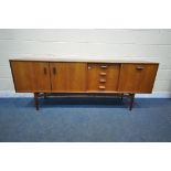 A MID CENTURY TEAK G PLAN SIDEBOARD, fitted with double cupboard doors, four recessed drawers, top