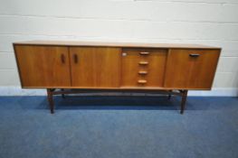 A MID CENTURY TEAK G PLAN SIDEBOARD, fitted with double cupboard doors, four recessed drawers, top