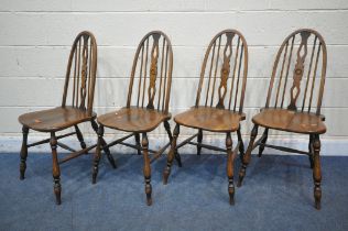 A SET OF FOUR REPRODUCTION ELM SEATED SPINDLE BACK CHAIRS, on turned legs and stretchers (