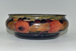 A MOORCROFT POTTERY POMEGRANATE BOWL, decorated with pomegranates on a mottled blue ground,