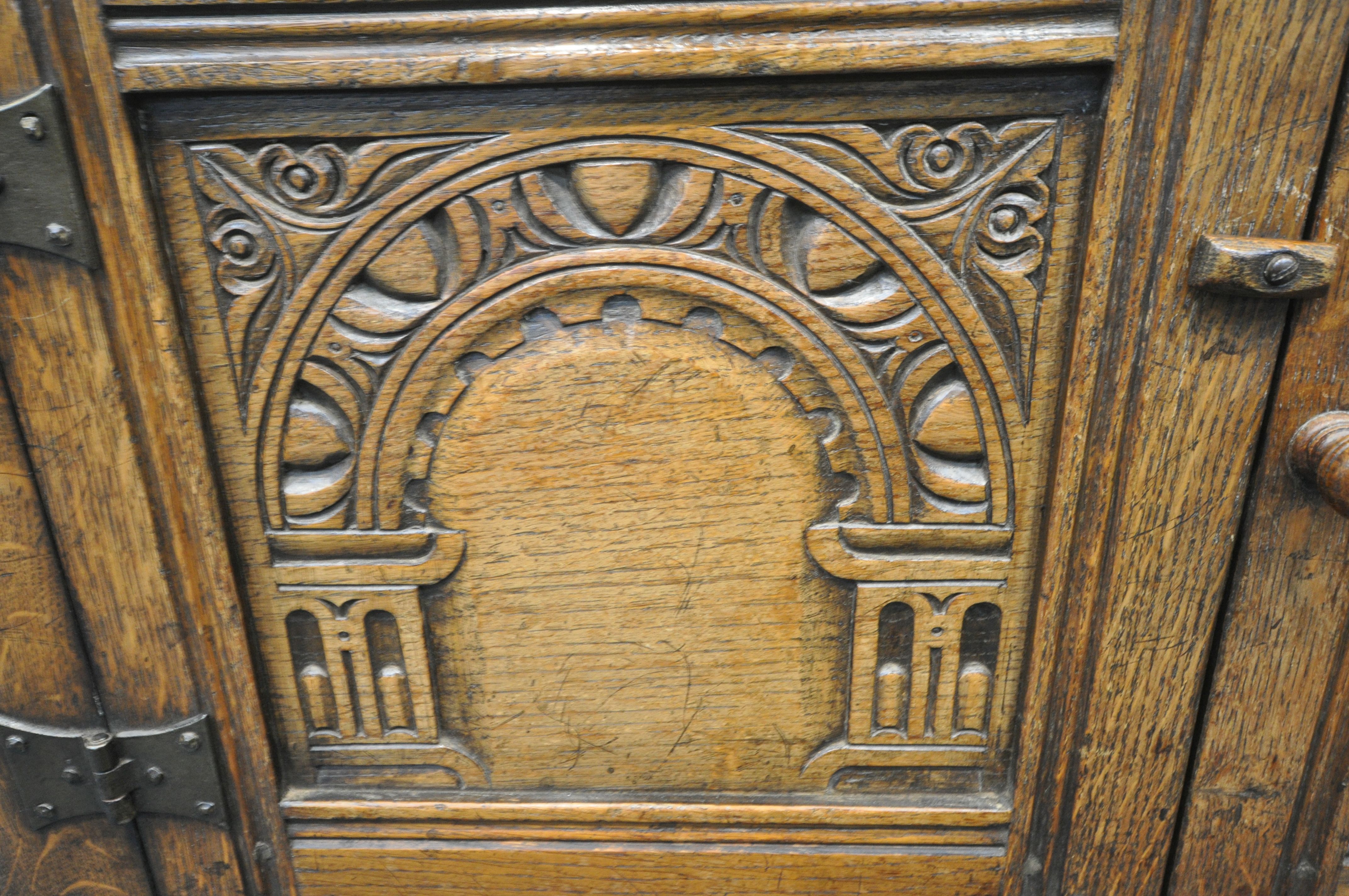 A 20TH CENTURY SOLID OAK CABINET, fitted with two cupboard doors, carved with an archway, a brushing - Image 3 of 6