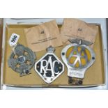 THREE VINTAGE CAR BADGES AND TWO AA ENVELOPES CONTAINING EMERGENCY ROADSIDE KEYS, the car badges,