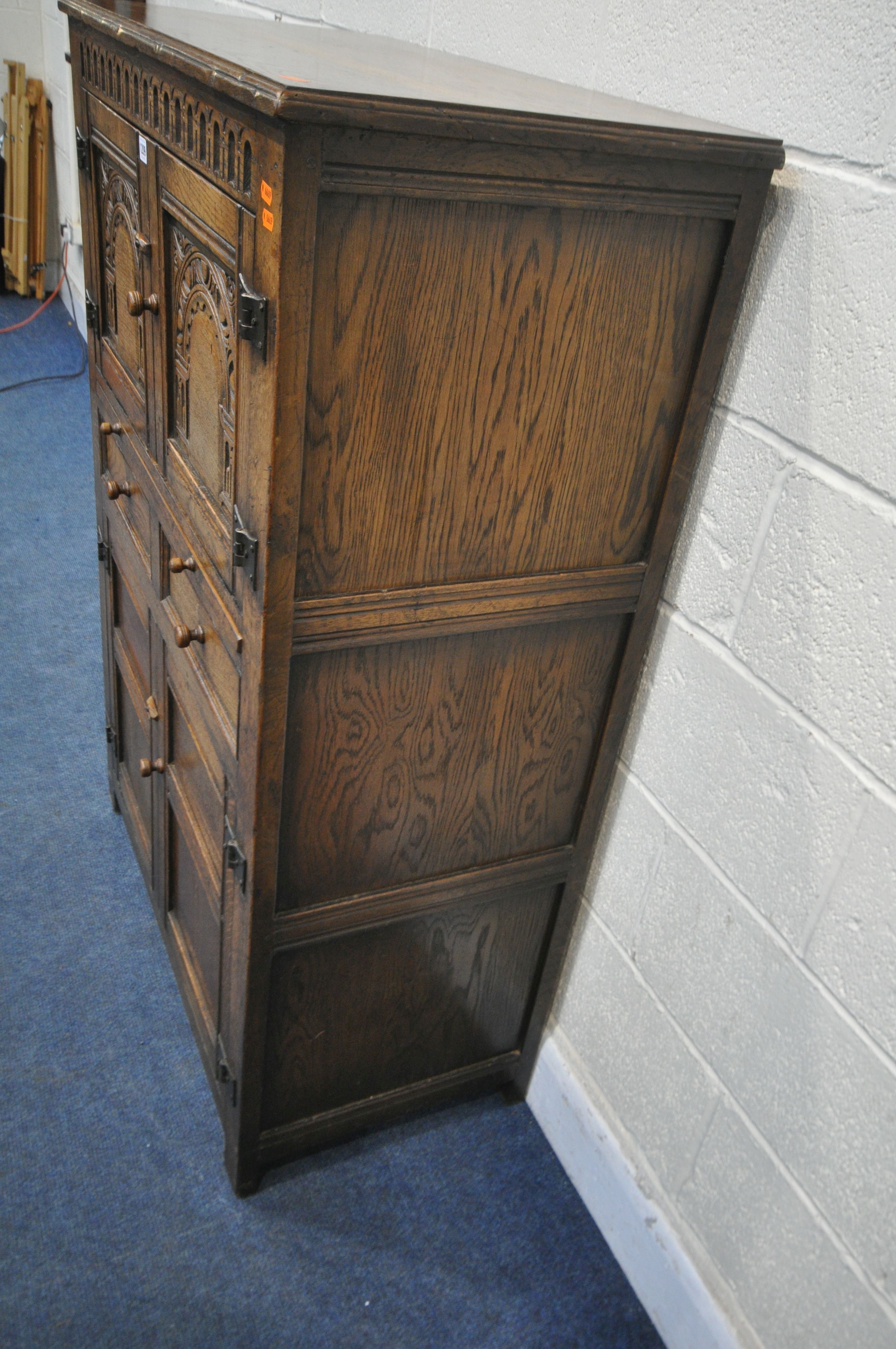 A 20TH CENTURY SOLID OAK CABINET, fitted with two cupboard doors, carved with an archway, a brushing - Image 6 of 6