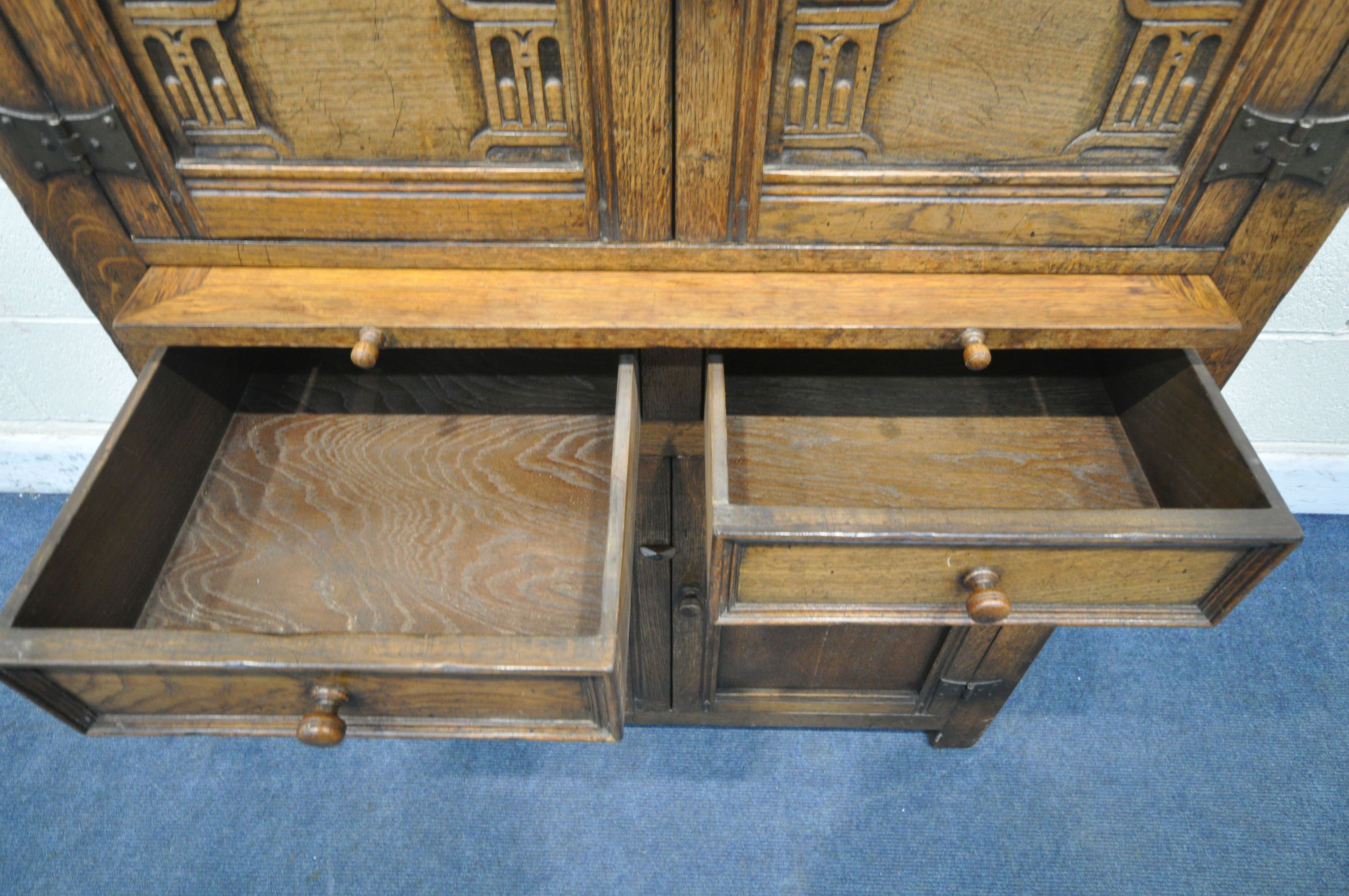 A 20TH CENTURY SOLID OAK CABINET, fitted with two cupboard doors, carved with an archway, a brushing - Image 4 of 6