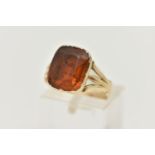 A MID VICTORIAN PASTE RING, the rectangular orange paste in a closed back setting, to the